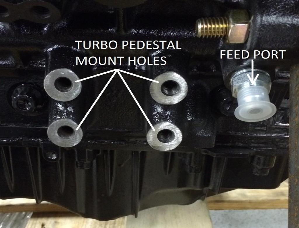 2. On the passenger side front of the engine block you will see the 4 bolt holes that our Twin Turbo pedestal fastens to for twin turbo kits (pictured below) just in front of the upper right hole is