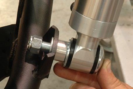 Put a 1/2 SAE flat washer on the inside of the mount tab followed by the locknut.