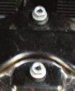 factory chrome section (right side shown) using the factory screws.