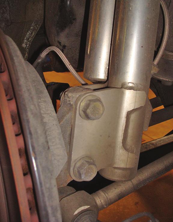 Remove the clips retaining the brake hose (Fig. 10).