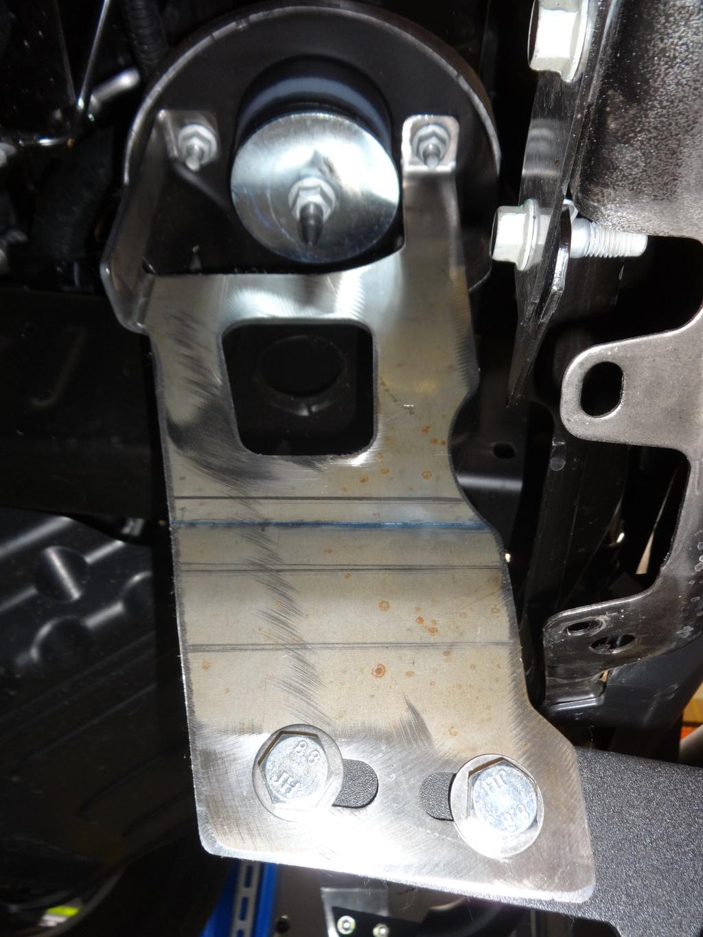 3. Locate the mounting location on the frame for the driver side bracket (item 2).