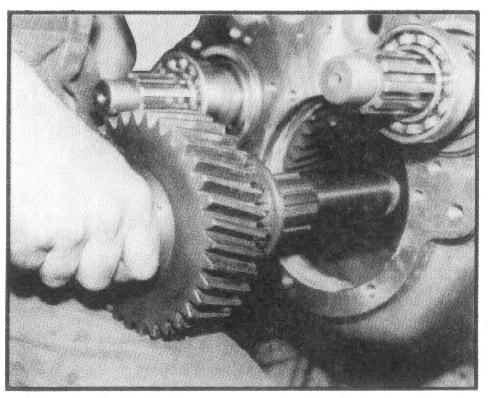 IV. TRANSFER CASE DISASSEMBLY 5. Withdraw intermediate shaft and direct drive gear through rear housing bore (See fig. 4). Remove clutch gear from shaft as it is removed. Remove block of wood. 6.