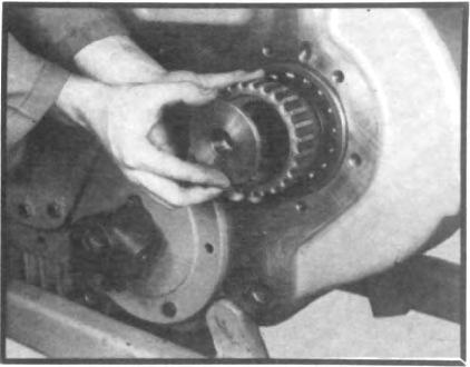 If transfer case is equipped with a PTO or direct pump drive, remove locking bolt from rear of shaft. (See fig. 24.