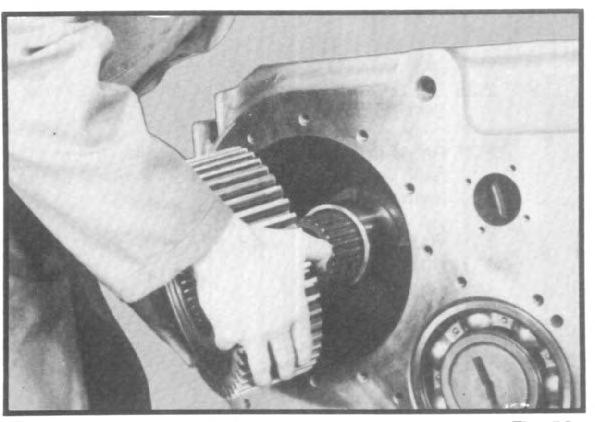 ) Remove two needle bearing assemblies from shaft or from inside the gear. Fig. 55 2.