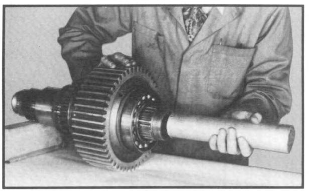 Attach a chain hoist with a sling around the direct drive gear and remove the shaft assembly through the rear case bore. (See fig. 72.
