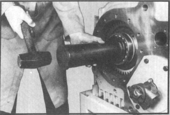 driver. (See fig. 106.) With a feeler gauge, measure the end play between gear ends and thrust washers.