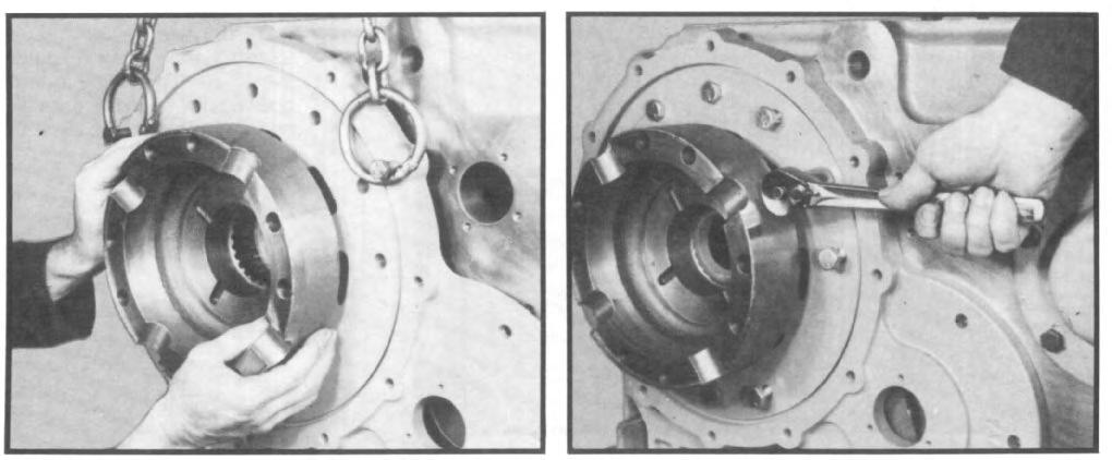 13 Using a chain hoist, install rear face plate and gasket to housing by first inserting the front of the differential case onto the lower shaft spline