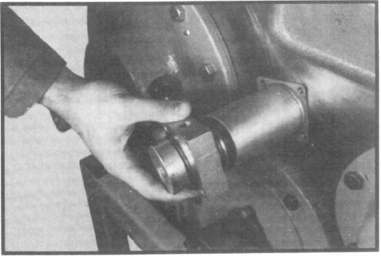 VII. TRANSFER CASE ASSEMBLY 10. Coat the shift cylinder tube lightly with gear lubricant, install cylinder tube over piston and seat against adapter tube. (See fig. 199.) 11.