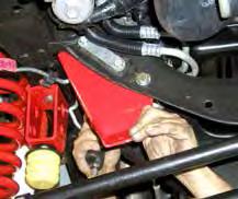 Remove the OEM steering stabilizer & OEM steering stabilizer bracket from the cross member using a 18mm socket. (See Photo # 23) 34.