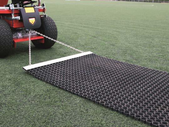 The process involves pulling a brush or mat behind a suitable grounds vehicle, and is performed to maintain a consistent distribution of infill.