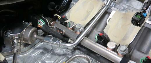 Using a 3/8 fuel line tool, disconnect the fuel line from the
