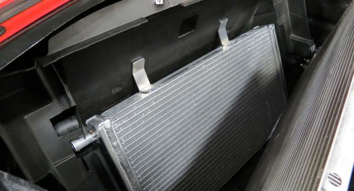 52. Lower the vehicle and position the LTR into the radiator shroud cavity making sure the