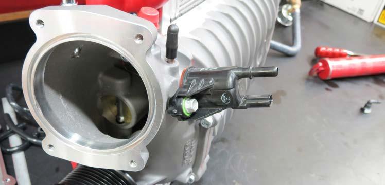 113. Using a 10mm socket, remove the EVAP solenoid from the stock manifold and install it onto the supercharger manifold