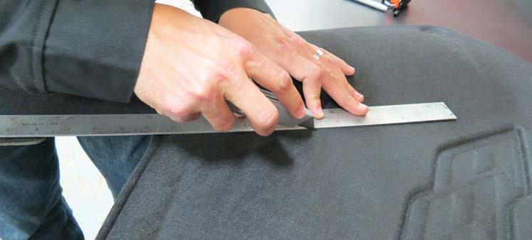 Using a straight edge and sharp utility knife, carefully cut the hoodliner along the left vertical embossing starting
