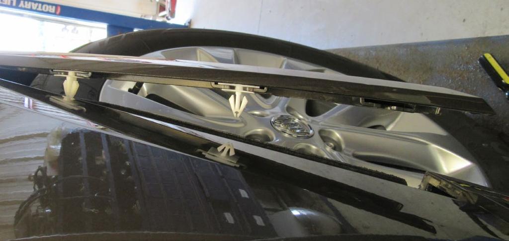 Then release the clips from the fender flare (left, white