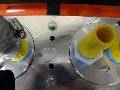 Emptying the Coolant Filters The coolant trap containers must be emptied when full to keep coolant from entering the system and potentially damaging the pump. This procedure is explained below.