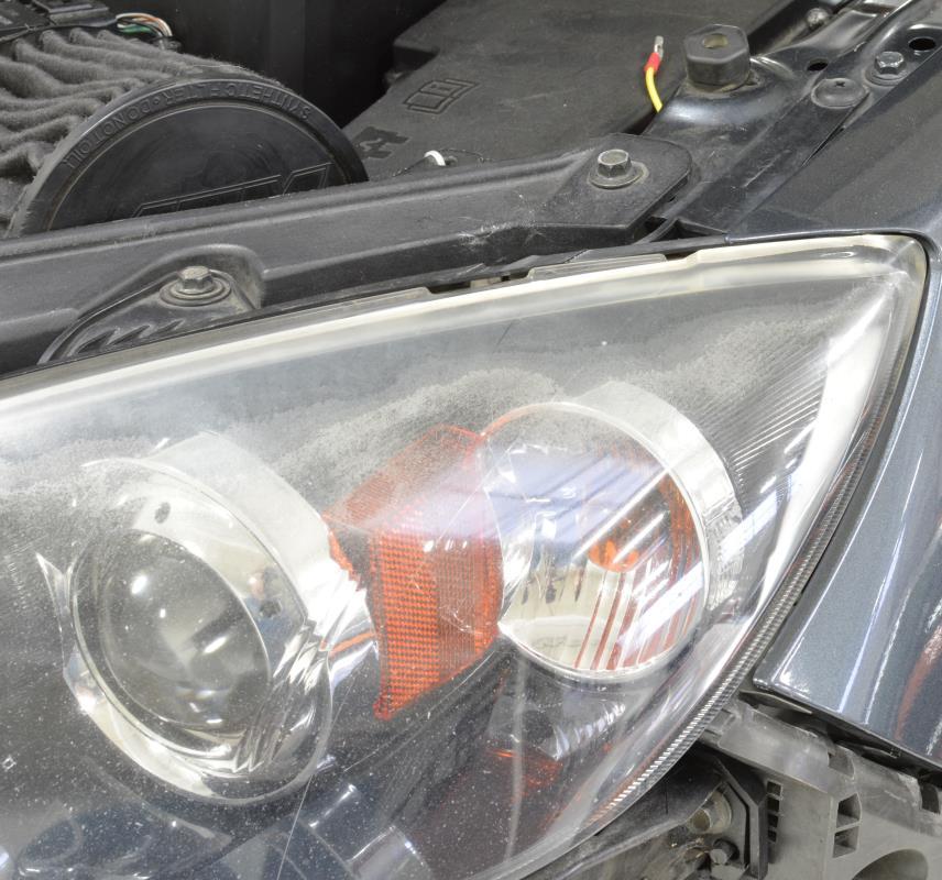 b) Remove three (3) 10mm bolts from the headlight.