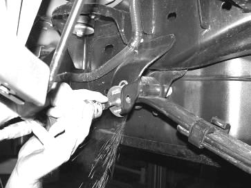 If your truck has a factory bolt on E-Brake Cable bracket on the driver side leaf spring hanger, remove the E-brake cable from the bracket and