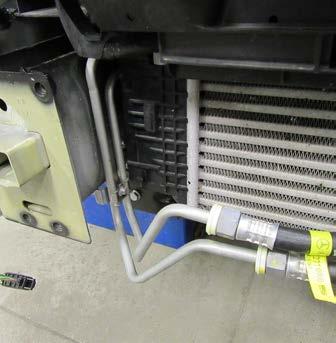 11. On the passenger side, using a 8MM socket, remove the bolt from the compressor line