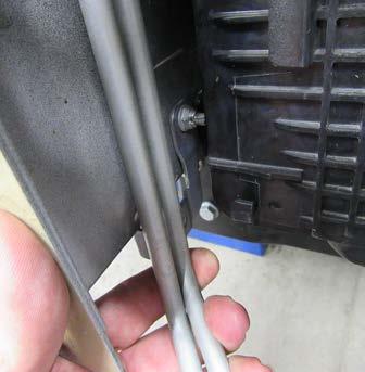 Trim the bracket stud flush with the frame being careful not to hit the condensor lines.