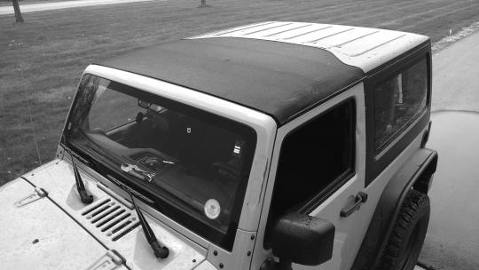 Section 9 Open and Secure Sunrider (optional) Page 12 Hardware 410.42 1 2 Sunrider Tie-Down Straps Part # 410.42 Wrap strap twice around From inside the Jeep, locate the two Windshield Header Latches.
