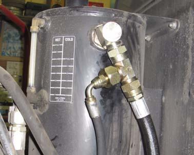 Connect the tank hose V from the T port on the automated steering block to the reducer fitting H on the hydraulic reservoir
