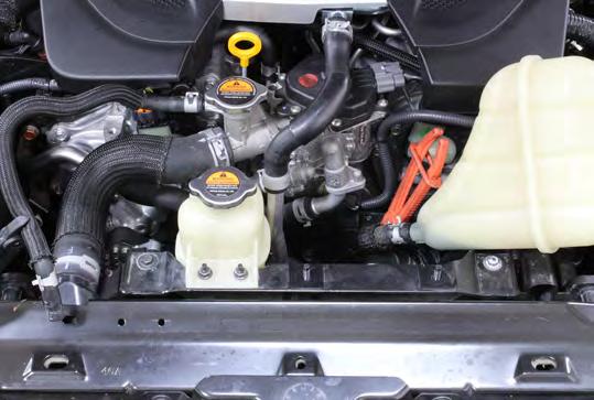 5 Disassembly Guide 03. Remove the two 10mm nuts holding the radiator expansion tank down and pull it over to the side.