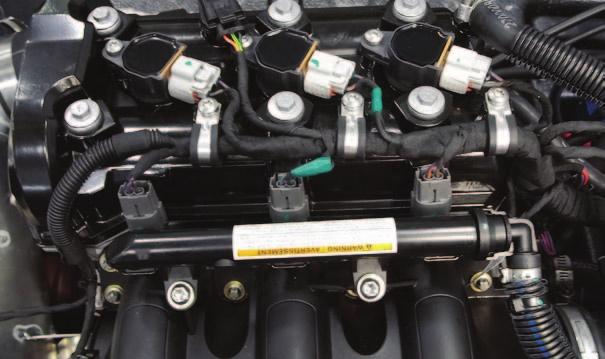 E 8 Locate and unplug the 3 fuel injectors (Fig. E). FIG.