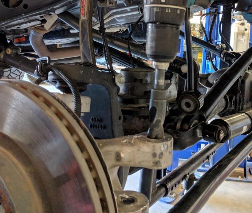 5. Loosen the nuts securing the factory drag link tie rod ends at both the steering knuckle and the pitman arm. Leave them on the tie rod ends with only one or two complete turns of engagement.