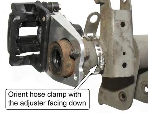 10. Wrap the hose clamp around the axle housing and loosely secure it so the position of the Brake Hose Mounting Bracket can still be adjusted.