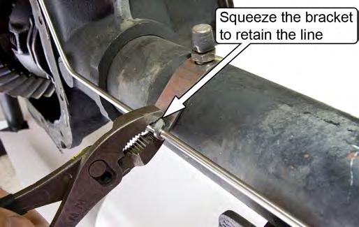 Slightly squeeze the Brake Hard Line Mounting Bracket with a pair of pliers.