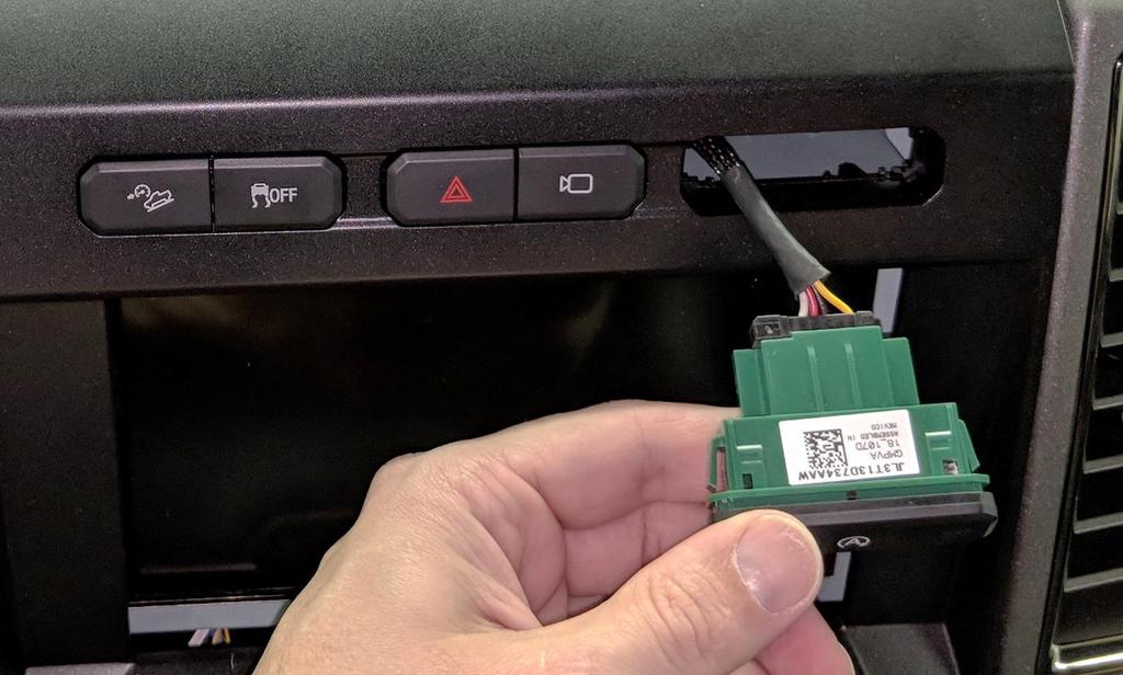 14. Connect the switch assembly and insert it back into the infotainment bezel. 15. Start the vehicle and verify the auto start-stop Off indicator is illuminated.