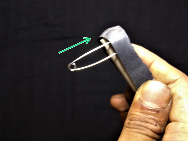 Step 2 - Adding Contacts Insert a safety pin (head-first) in between the battery and the elastic
