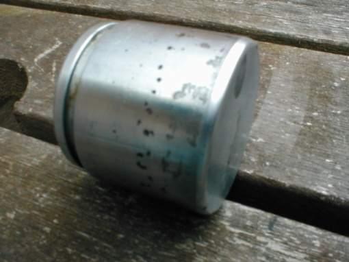Piston removed, showing that it is Old piston and new Stainless Steel badly pitted and in need of replacement item Sliding pins in good condition, just need a cleanup and