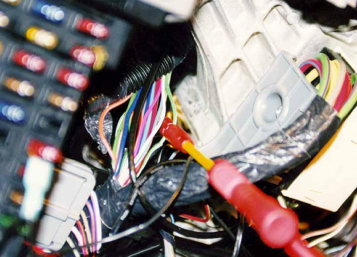 37. Locate the GREEN WITH WHITE STRIPE wire from within the wire bundle. Turn the ignition key so that electrical power is on and activate the driver side turn indicator.