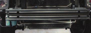 Remove the plastic deflectors located on each side of the radiator by removing the plastic retaining clips with a panel puller.