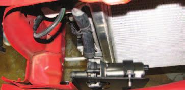 Install the long 3/4 hose onto the driver side barb of the heat exchanger and secure it with a clamp.