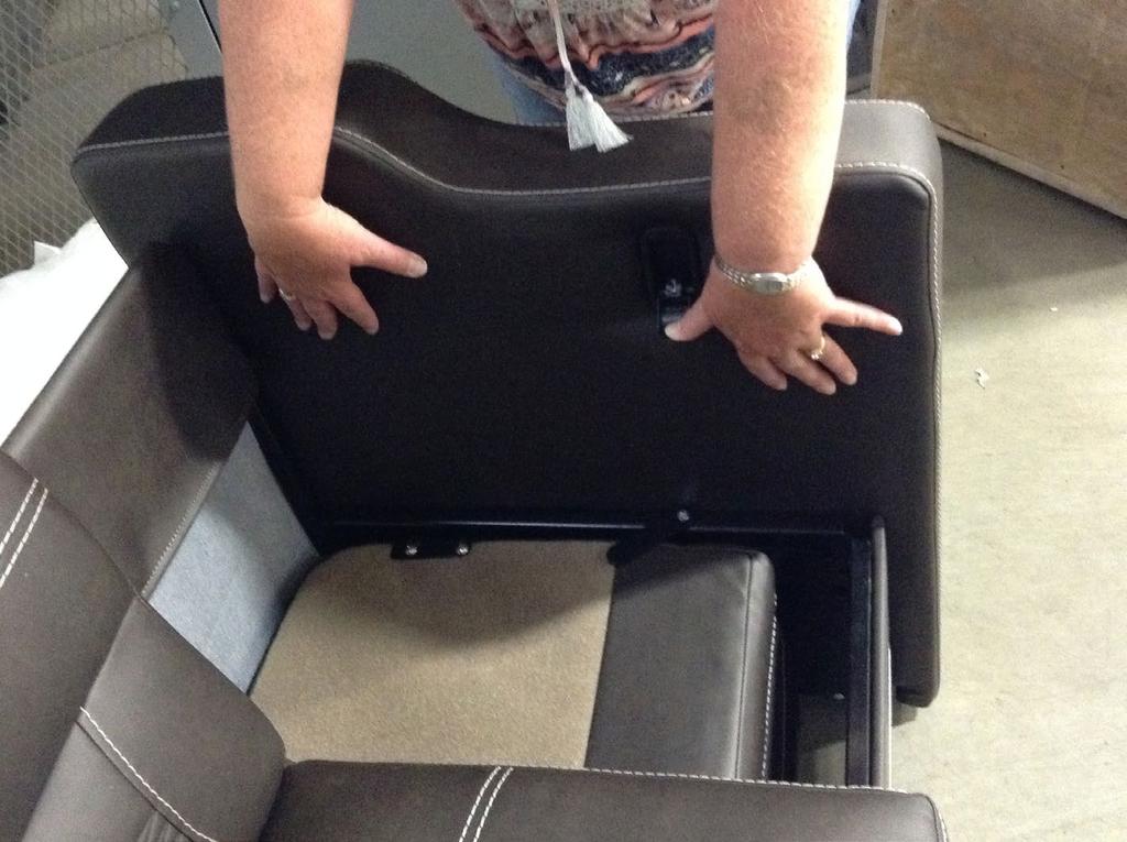 2. While continuing to hold down the locking latch (Fig. 2), use both hands to pull the armrest straight out.