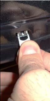 disengage the plastic nut located at the front slot of the