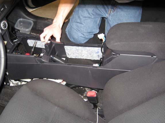 Open the storage compartment on the rear center console.