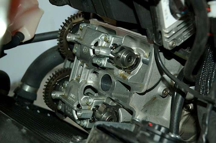 After removing the 4 head cover bolts and the spark plug boot, you can remove the head cover.