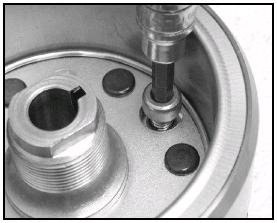 When turning the starter wheel gear counter clockwise a), the starter clutch and the wheel gear should be engaged. If not, the starter clutch is faulty. Replace it. 6.