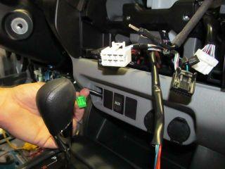 Remove the switch plug above the center console.