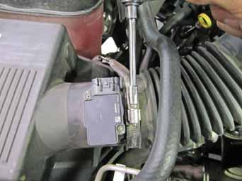 Remove the engine cover; lift up to release the tabs from the grommets that secure it in place. b.