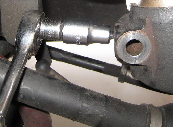 way. Note: Safely hang the caliper using a zip tie or wire hanger so that it doesn t over-extend or damage the brake line. Photo 5 13.