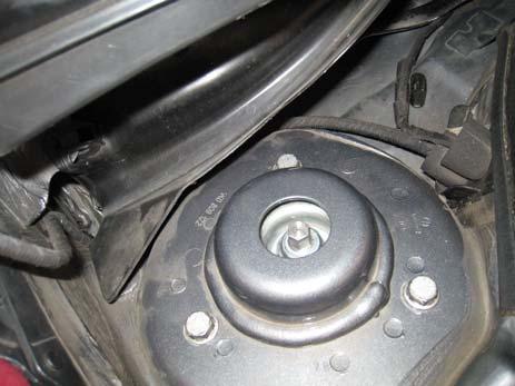 16. Install the OE upper strut mount onto the Eibach front coilover and secure it with the