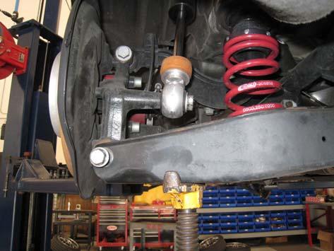 Using the stock upper isolator install the rear spring