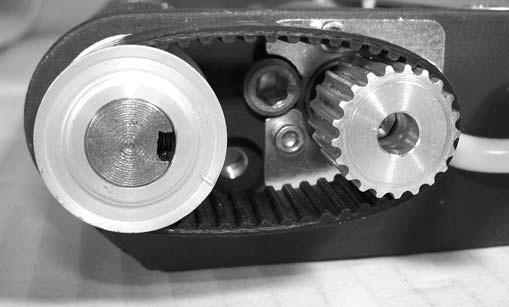 Tighten timing belt tension cam (Figure 65, item ), making certain that pointer (Figure 65, item ) on cam is pointing towards the motor drive spindle (Figure 65, item ).