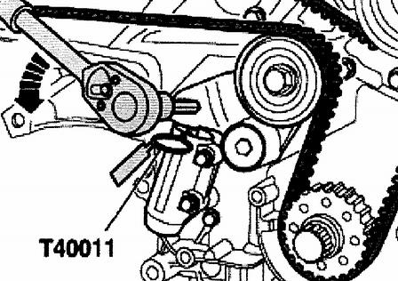 Using 8 mm socket head wrench, turn toothed belt tensioning roller in direction of arrow until T40011
