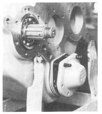 11. Temporarily install the rear output shaft front cover (See Fig. 17). Do not install shims. Tighten the mounting bolts to approximately 25 lb. ft. torque.